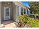 Charming front entrance with a light-colored door, white trim, and well-maintained landscaping at 14820 Potterton Cir, Hudson, FL 34667