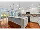 Bright kitchen with a large center island, modern appliances, and hardwood floors at 14820 Potterton Cir, Hudson, FL 34667