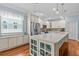 Bright and airy kitchen with a large center island and stainless-steel appliances at 14820 Potterton Cir, Hudson, FL 34667