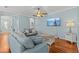 Cozy living room featuring hardwood floors, comfortable sofas, and a relaxing atmosphere at 14820 Potterton Cir, Hudson, FL 34667