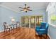 Cozy sitting room with wood floors, comfortable chairs, and ample natural light at 14820 Potterton Cir, Hudson, FL 34667