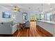 Open living room with hardwood floors, ceiling fans, and a seamless flow to the kitchen at 14820 Potterton Cir, Hudson, FL 34667