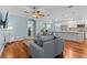 Spacious living room with hardwood floors, comfortable seating, and natural light at 14820 Potterton Cir, Hudson, FL 34667