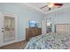 Comfortable main bedroom features light blue walls, a ceiling fan, and a wooden dresser with a flat screen TV at 14820 Potterton Cir, Hudson, FL 34667