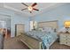 Serene main bedroom with a tray ceiling, a ceiling fan, and a calm ambiance at 14820 Potterton Cir, Hudson, FL 34667