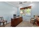 Home office featuring a large desk, comfortable seating, and neutral carpeting at 14820 Potterton Cir, Hudson, FL 34667