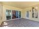 Enclosed patio area with tiled floor, sliding glass doors, and a view of the backyard at 14820 Potterton Cir, Hudson, FL 34667