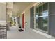 Inviting covered front porch with stone pillars, a red door, and ample natural light at 3320 Prescott N St, St Petersburg, FL 33713