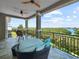 A covered balcony with lounge furniture, a view of the bay, and black metal railings at 7020 Hawks Harbor Cir, Bradenton, FL 34207