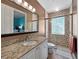 Bathroom featuring a vanity with granite countertop and glass block shower with updated fixtures at 7020 Hawks Harbor Cir, Bradenton, FL 34207