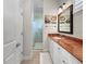 Bathroom featuring a glass shower, marbled countertop, a decorative painting, and updated fixtures at 7020 Hawks Harbor Cir, Bradenton, FL 34207