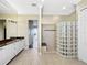 Bathroom featuring a vanity with granite countertop and a block glass walk-in shower at 7020 Hawks Harbor Cir, Bradenton, FL 34207