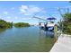 Boat lift on the water with a boat, offering waterfront living and recreation at 7020 Hawks Harbor Cir, Bradenton, FL 34207