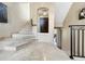 Elegant foyer featuring marble flooring, staircase with iron railing, and a view of the front door at 7020 Hawks Harbor Cir, Bradenton, FL 34207
