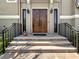 Inviting front entrance with a solid wood double door, sidelights, and decorative sconces at 7020 Hawks Harbor Cir, Bradenton, FL 34207