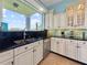 Well-appointed kitchen with stainless steel appliances, stone countertops, and a view of the backyard at 7020 Hawks Harbor Cir, Bradenton, FL 34207