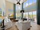 Bright living room with high ceilings, large windows, and stylish furnishings at 7020 Hawks Harbor Cir, Bradenton, FL 34207