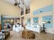 Bright living room with high ceilings, large windows, and stylish furnishings at 7020 Hawks Harbor Cir, Bradenton, FL 34207