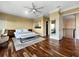 Spacious main bedroom with hardwood floors, ceiling fan, and a doorway to the balcony at 7020 Hawks Harbor Cir, Bradenton, FL 34207