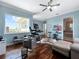 Home office featuring hardwood floors, blue walls, a large window with a view, and desk setup at 7020 Hawks Harbor Cir, Bradenton, FL 34207