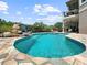 Inviting pool featuring a unique rock waterfall and flagstone surround at 7020 Hawks Harbor Cir, Bradenton, FL 34207