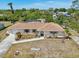 Spacious single-story home surrounded by lush greenery and mature trees at 3067 Iverson St, Port Charlotte, FL 33952