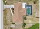 Aerial shot of house showcasing roof, pool, nearby shed and surrounding neighborhood at 3067 Iverson St, Port Charlotte, FL 33952
