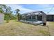 Lush backyard showcasing a screened pool area, a storage shed, and a well-maintained lawn, ideal for outdoor activities at 3067 Iverson St, Port Charlotte, FL 33952