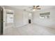 Bright bedroom featuring tile flooring, ceiling fan, and convenient access to the bathroom and hallway at 3067 Iverson St, Port Charlotte, FL 33952