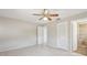 Sunlit bedroom features tile floors, a fan, and convenient access to an attached bathroom with a tiled shower at 3067 Iverson St, Port Charlotte, FL 33952