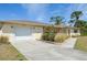 Cozy single-story home with an attached garage and a well-maintained lawn at 3067 Iverson St, Port Charlotte, FL 33952