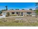 Charming single-story home featuring a well-manicured lawn and neutral exterior paint at 3067 Iverson St, Port Charlotte, FL 33952