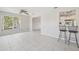Bright living room with a breakfast bar, tile flooring, and open views at 3067 Iverson St, Port Charlotte, FL 33952