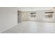 Spacious living room featuring tile flooring, a front door, and natural light from two windows at 3067 Iverson St, Port Charlotte, FL 33952