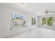 Bright living room with white tile floors and large windows overlooking the pool at 3067 Iverson St, Port Charlotte, FL 33952