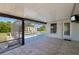 Covered patio area with tiled flooring, leading to a screened-in pool and lush backyard with a storage shed at 3067 Iverson St, Port Charlotte, FL 33952