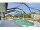 Screened-in in-ground pool with integrated steps and a spacious patio area for comfortable outdoor living and leisure at 3067 Iverson St, Port Charlotte, FL 33952