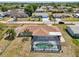Aerial view of the backyard pool and patio area with a beautiful statue focal point at 3067 Iverson St, Port Charlotte, FL 33952
