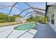 Inviting in-ground pool enclosed by a screened cage, providing a private and enjoyable outdoor retreat at 3067 Iverson St, Port Charlotte, FL 33952