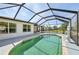 Well-maintained in-ground pool enclosed in a screened cage, offering a refreshing and secluded backyard oasis at 3067 Iverson St, Port Charlotte, FL 33952