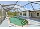 Sparkling in-ground pool with a screened enclosure, featuring steps and an adjacent lounge area for relaxation at 3067 Iverson St, Port Charlotte, FL 33952