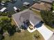 Stunning aerial view of waterfront home with boat lifts, lush landscaping, and a well-maintained lawn at 802 Eagle Ln, Apollo Beach, FL 33572