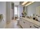 Bright bathroom features a walk-in shower, granite counters, white cabinets, and a large mirror at 802 Eagle Ln, Apollo Beach, FL 33572