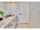 Bright bathroom features a granite countertop, white cabinets, and ample space, exuding tranquility and style at 802 Eagle Ln, Apollo Beach, FL 33572