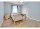 Serene bedroom with a comfortable bed, light wood floors, neutral tones, and natural light, creating a relaxing space at 802 Eagle Ln, Apollo Beach, FL 33572