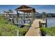 Wooden dock with boat lift offers private waterfront access and scenic views in a serene setting at 802 Eagle Ln, Apollo Beach, FL 33572