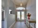 Inviting foyer with decorative tile flooring, glass double doors, elegant lighting, and neutral paint at 802 Eagle Ln, Apollo Beach, FL 33572
