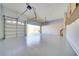 Spacious three-car garage featuring epoxy flooring, ample lighting, and smooth, painted walls at 802 Eagle Ln, Apollo Beach, FL 33572