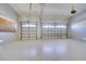 Spacious garage with epoxy flooring, multiple garage doors, and updated garage door mechanisms at 802 Eagle Ln, Apollo Beach, FL 33572