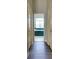 Hallway leads to the bright bathroom featuring tile and a large soaking tub at 802 Eagle Ln, Apollo Beach, FL 33572